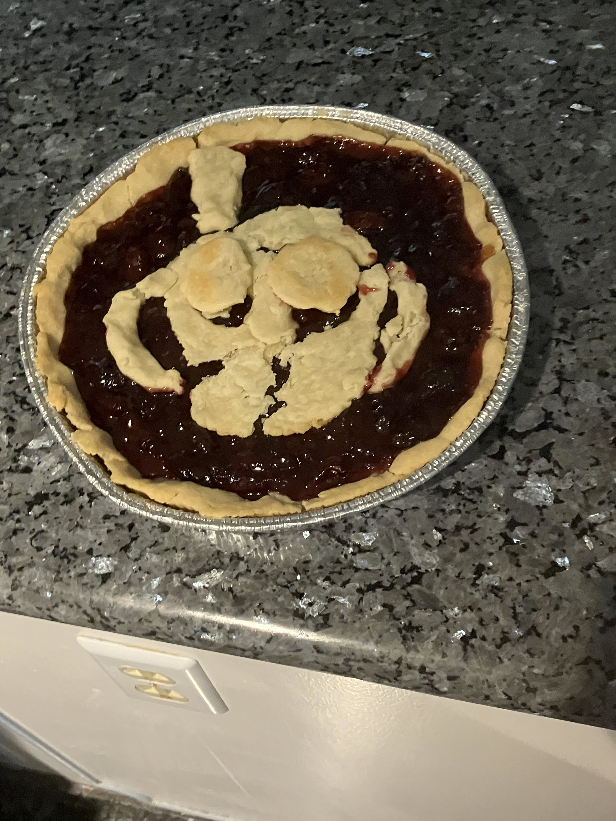 Cherry-bourbon pie with pie art of Ms. Chalice on top