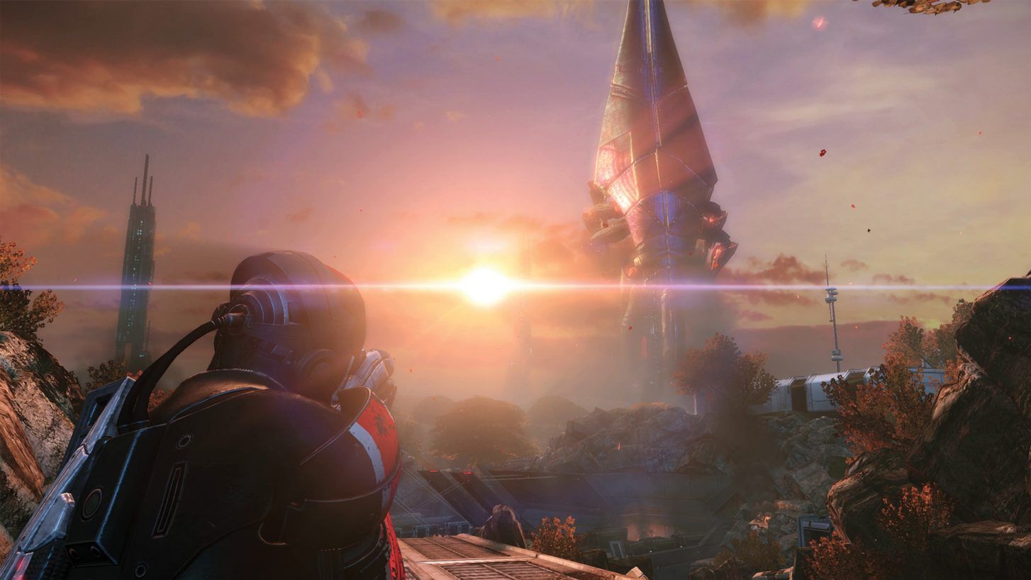 Mass Effect Legendary Edition Shepard looking at a huge Reaper approaching on the horizon.