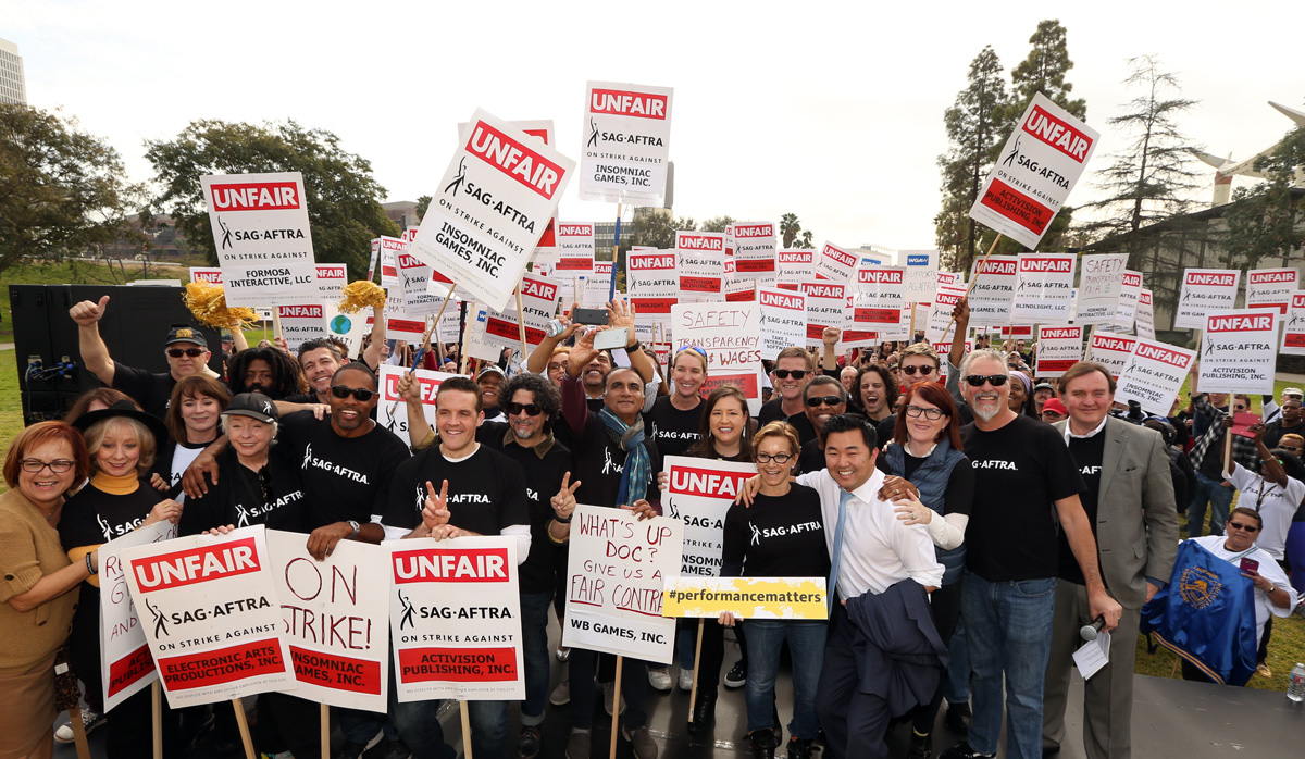 Protesters with signs reading "UNFAIR SAG-AFTRA" and similar slogans during the 2016 strike.