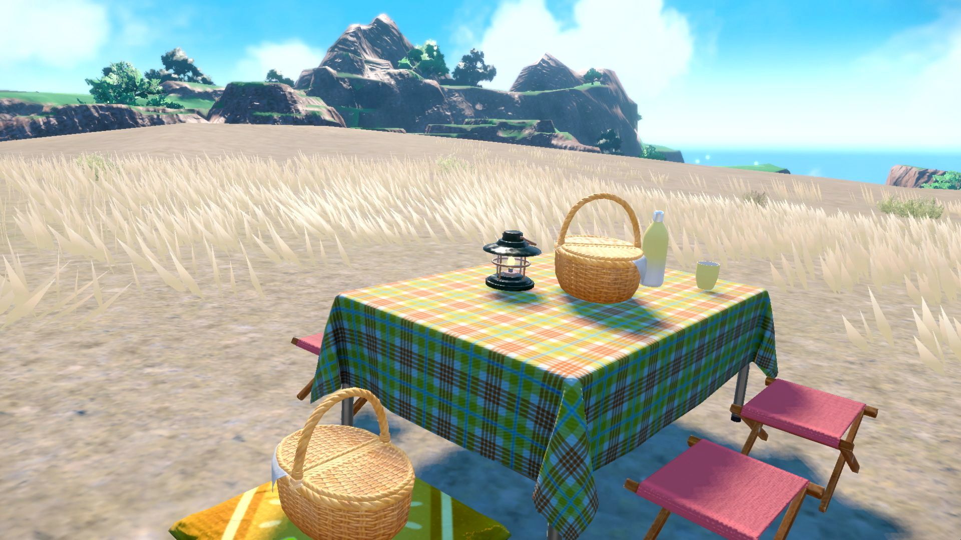 A picnic table set up on a grassy plain.