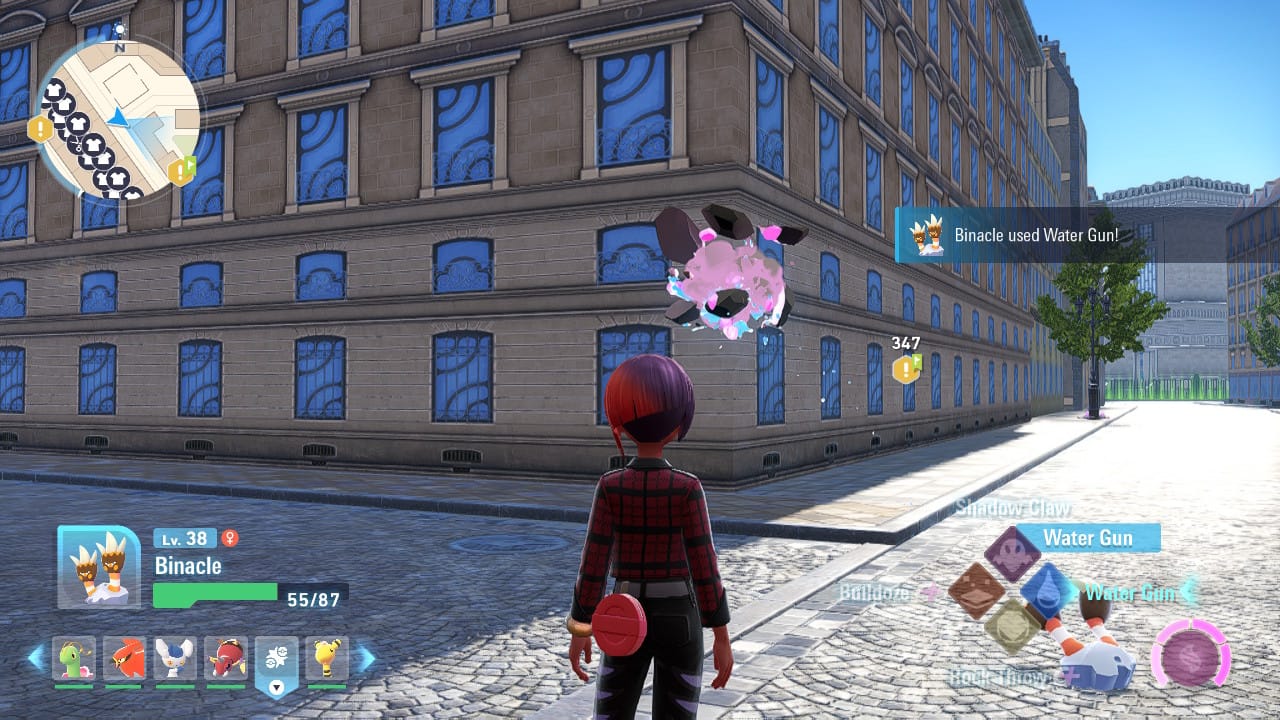 A Pokémon Legends Z-A screenshot featuring the player character and a Binacle in front of a building. Binacle has just used Water Gun to attack a Mega Stone on a building wall, which is indicated by an interface message on the right side of the screen.
