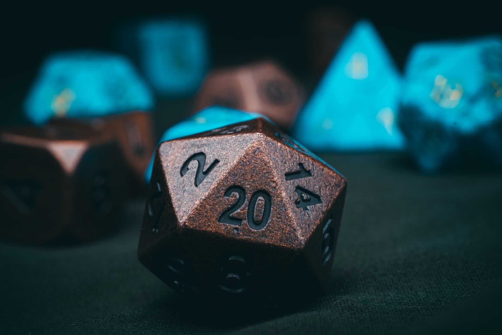 A rust-colored 20-sided die with the 20 face facing the camera