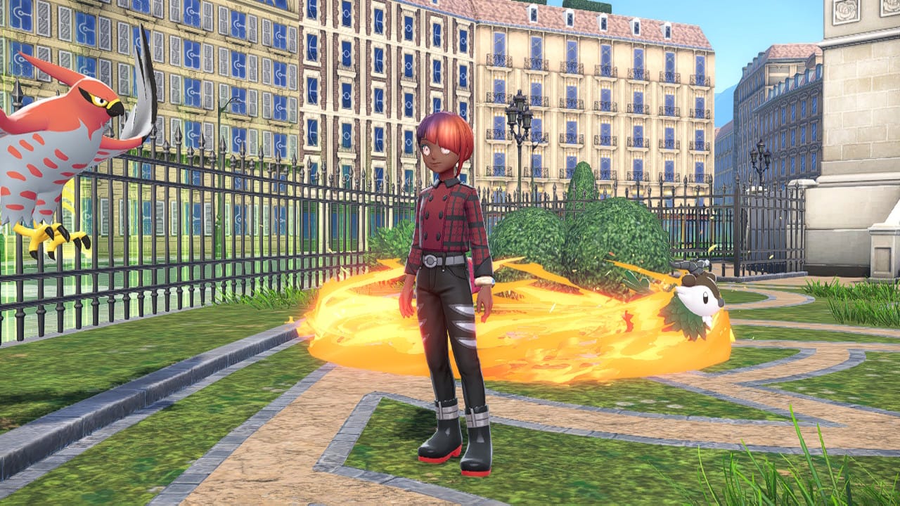 A Pokémon Legends Z-A screenshot featuring the player character, a Talonflame, and a fire ring move on the background in a park-like area, a Skiddo is burning.