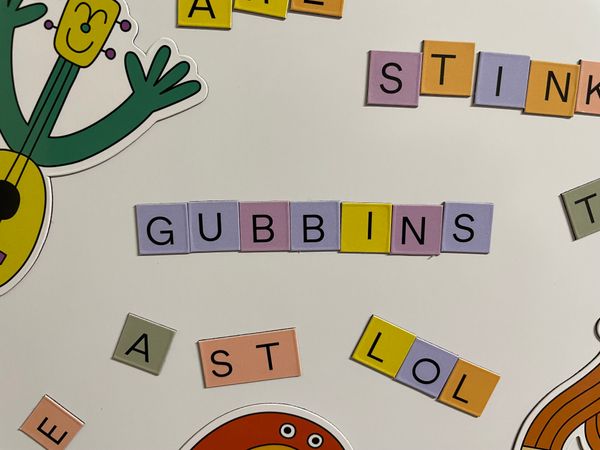The title 'Gubbins' written in the game's magnets on a fridge.